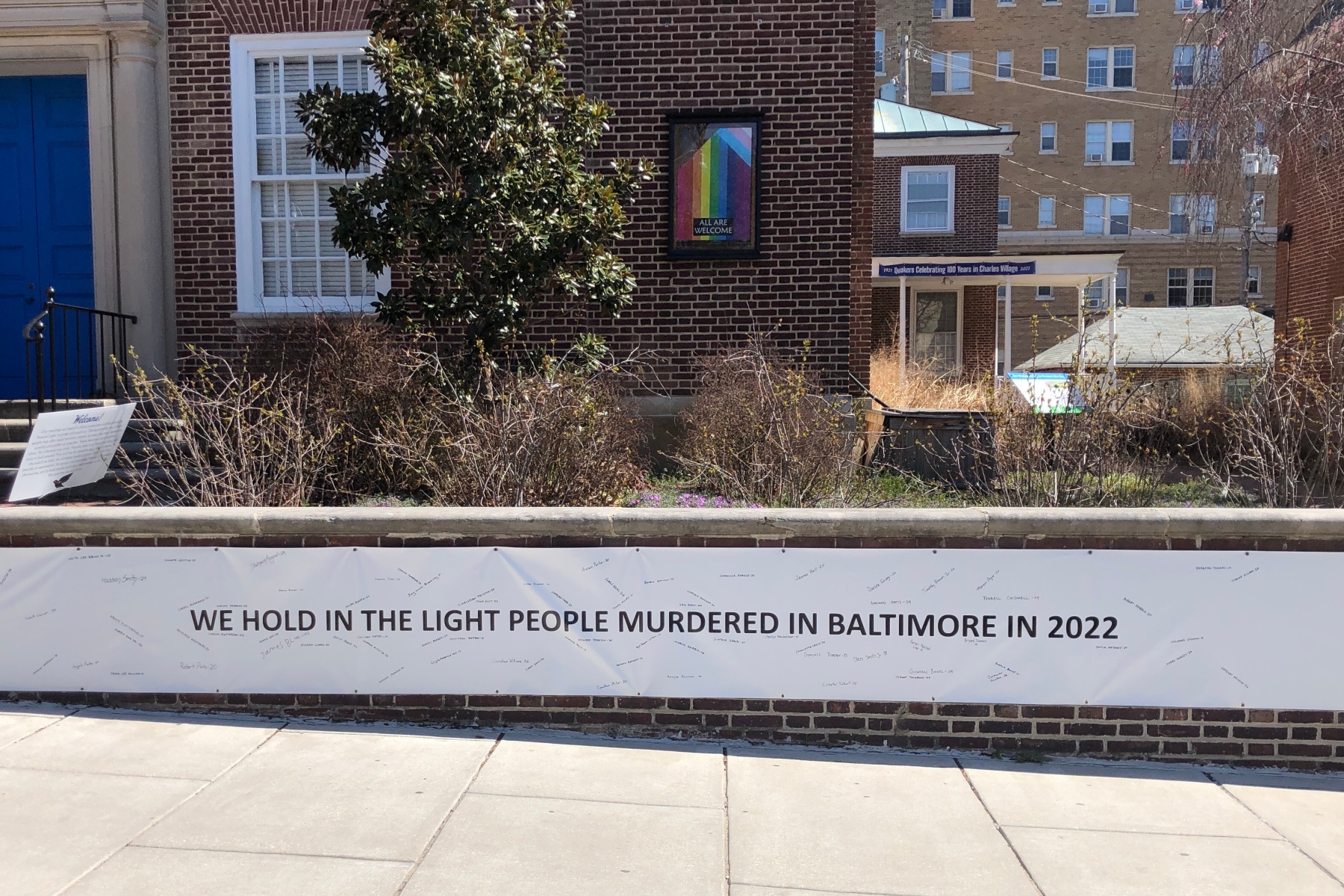 2022 banner with names of people who have been killed in Baltimore, in front of the meetinghouse